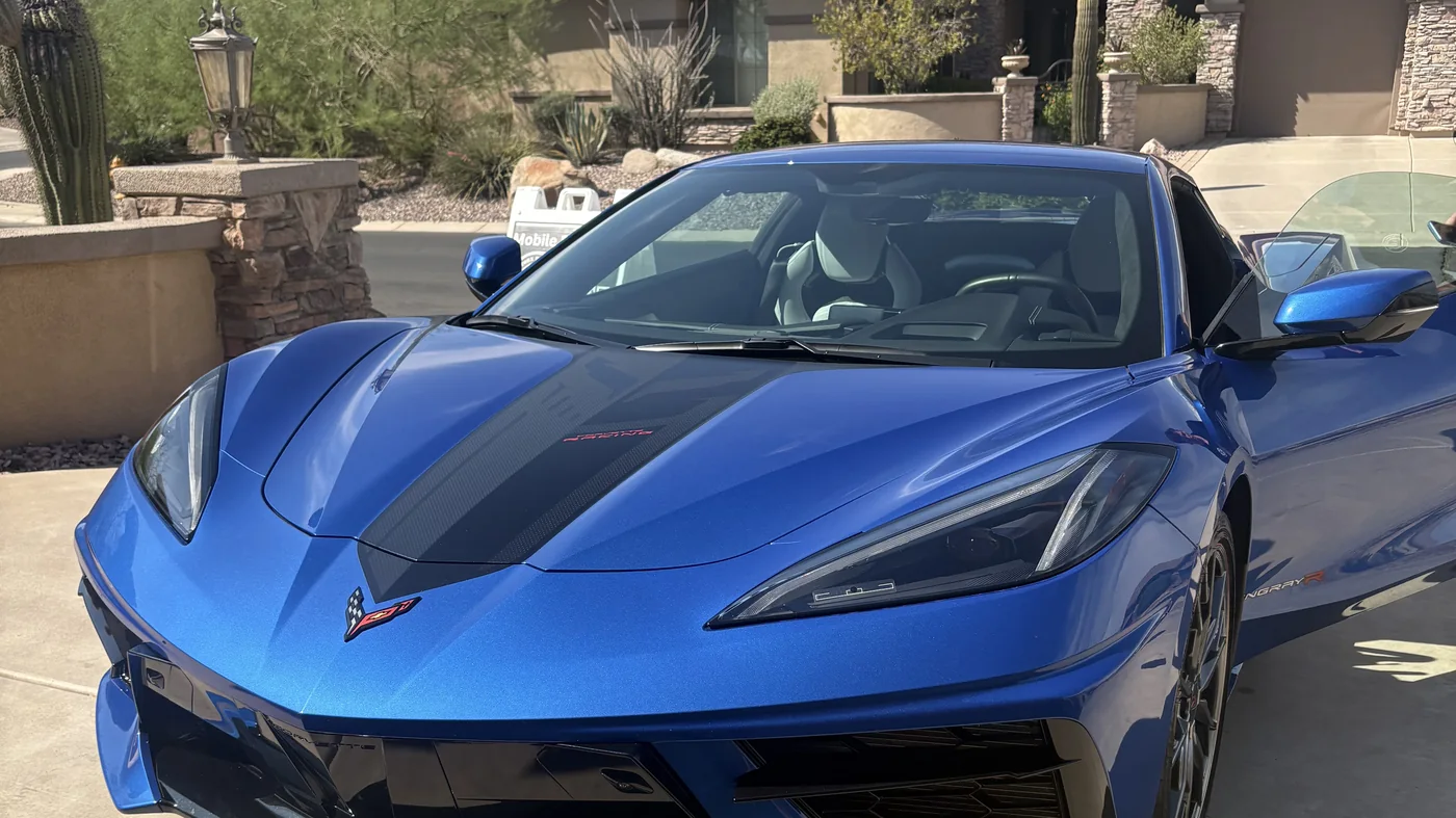 Blue Corvette C8 Stingray with corrected and ceramic coated paint in a North Phoenix driveway