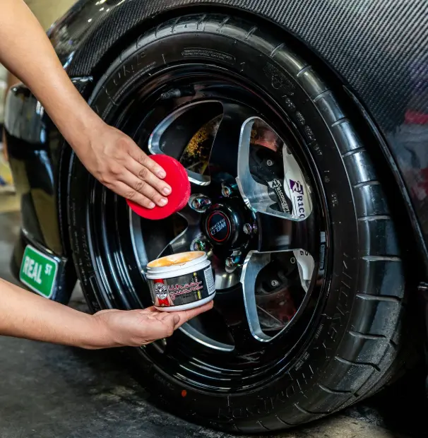Synthetic rim wax applied to black sports car wheel Phoenix AZ